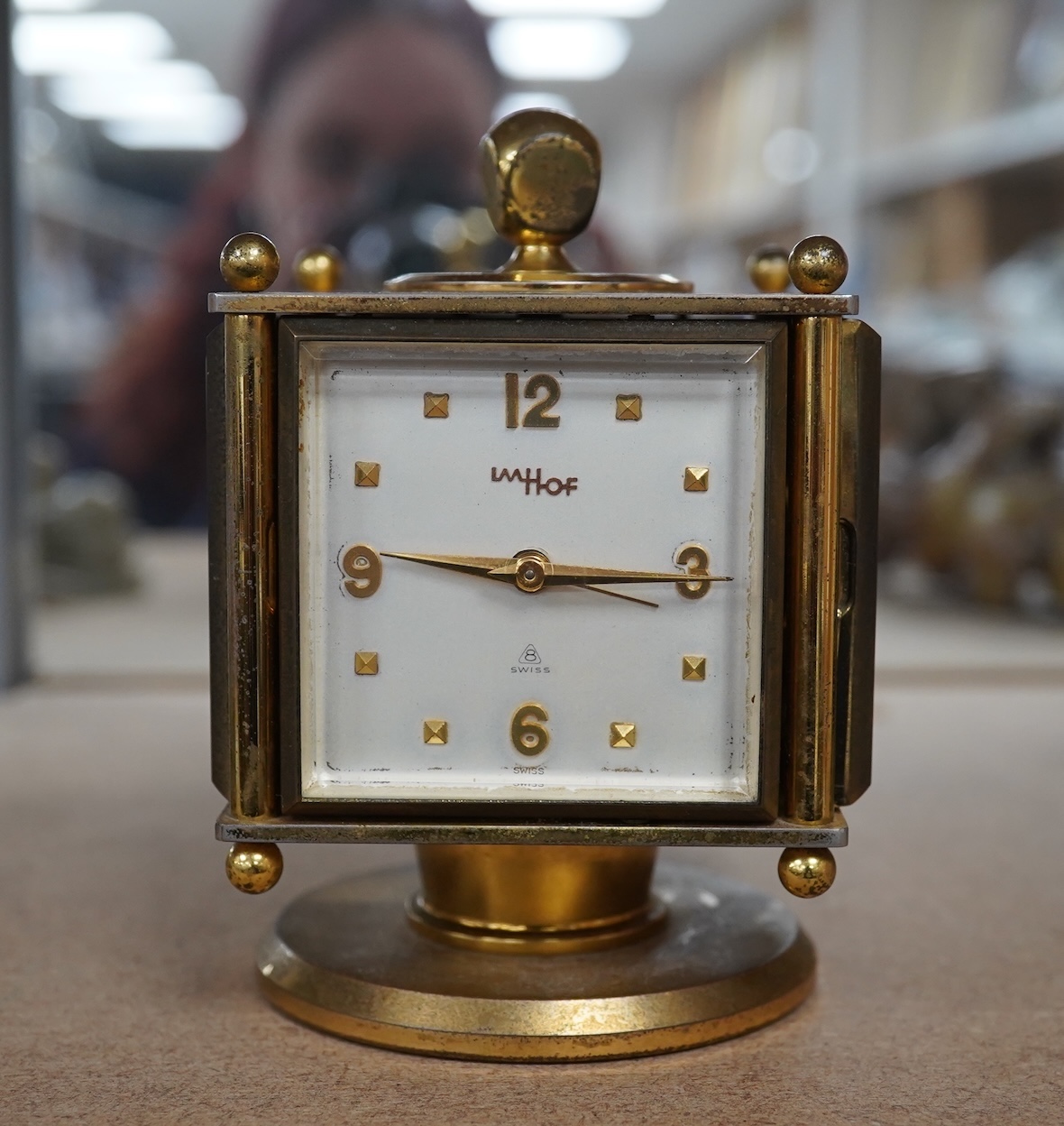 An Imhof brass combination clock, hydrometer, barometer and thermometer, 12cm high. Condition - fair